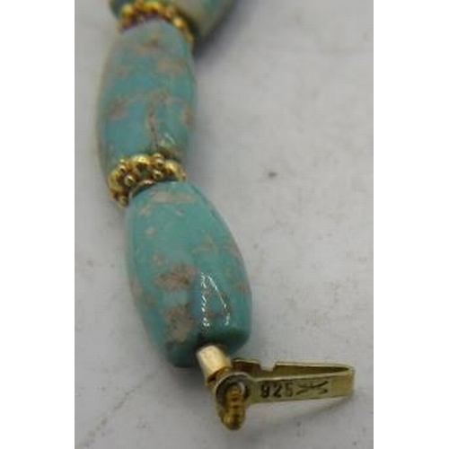 471 - An unusual graduated 'Kingman' turquoise necklace. The centre faceted oblong bead is approx 10mm x 2... 