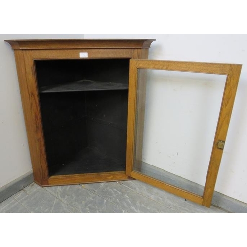 843 - A turn of the century medium oak wall-hanging glazed corner cupboard, with two loose shelves. 
H79cm... 