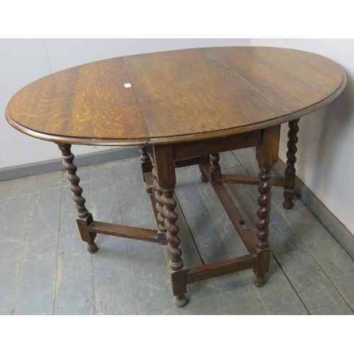 849 - A 19th century oak oval gate leg table on barley twist supports with stretchers. 
H73cm W91cm D42-11... 