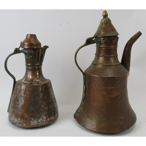 222 - Two Middle Eastern metalwork decanters. Comprising a copper jug of mallet form with hinged cover tog... 