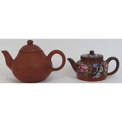 122 - Two Chinese yixing teapots. The larger teapot with impressed seal mark and the smaller overglaze pai... 