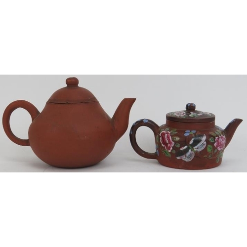 122 - Two Chinese yixing teapots. The larger teapot with impressed seal mark and the smaller overglaze pai... 