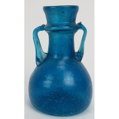 123 - A Roman turquoise blue glass miniature amphora. 3.2 in (8 cm) height. 
Condition report: Good condit... 