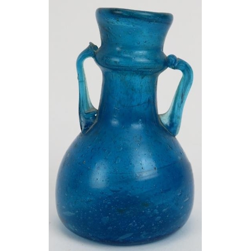 123 - A Roman turquoise blue glass miniature amphora. 3.2 in (8 cm) height. 
Condition report: Good condit... 