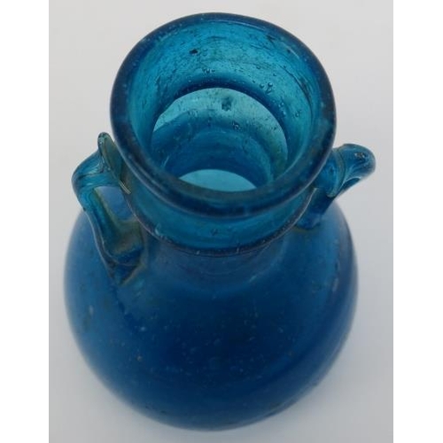 123 - A Roman turquoise blue glass miniature amphora. 3.2 in (8 cm) height. 
Condition report: Good condit... 