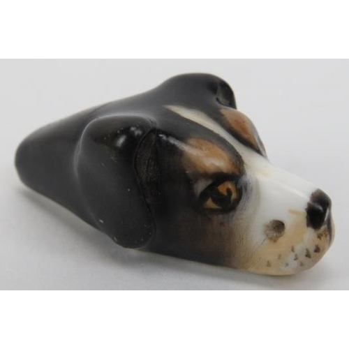 124 - A Royal Worcester dogs head whistle. The hunting dog with painted features and Royal Worcester puce ... 