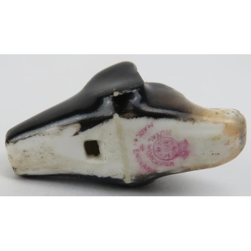 124 - A Royal Worcester dogs head whistle. The hunting dog with painted features and Royal Worcester puce ... 