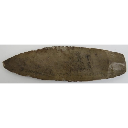 160 - A Neolithic Stone Age stone spearhead and five arrow heads. Indistinct later written English inscrip... 