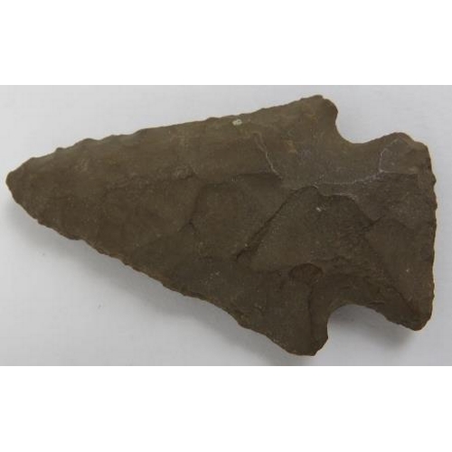 160 - A Neolithic Stone Age stone spearhead and five arrow heads. Indistinct later written English inscrip... 