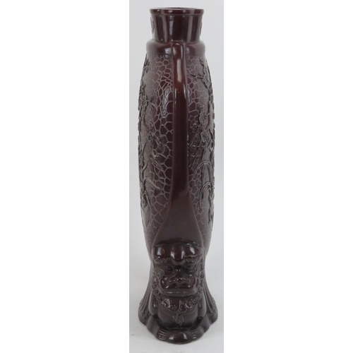 163 - A Chinese sang de boeuf glazed vase, 20th century. Of compressed form with decoration moulded in rel... 