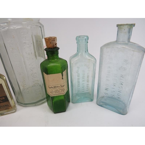 169 - A collection of vintage and antique glassware. Comparing nine Chemists, medication and alcohol bottl... 