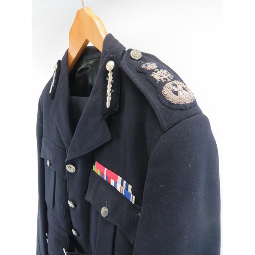 180 - A British Police officer’s uniform, mid/late 20th century. A brown leather belt is also included. Pr... 