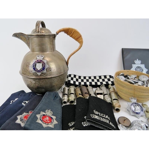 190 - A large collection of mainly British Police officer’s cap badges, buttons, whistles and other items ... 