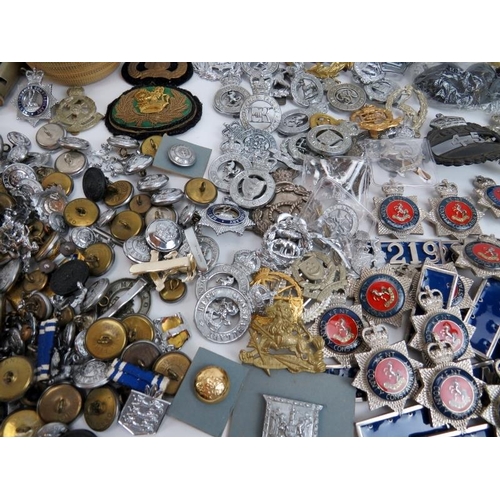 190 - A large collection of mainly British Police officer’s cap badges, buttons, whistles and other items ... 