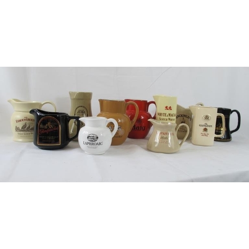 218 - Breweriana: Comprising eleven ceramic pub water jugs, advertising various whisky brands. (11).
Condi... 