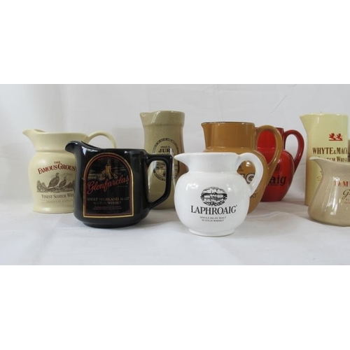 218 - Breweriana: Comprising eleven ceramic pub water jugs, advertising various whisky brands. (11).
Condi... 