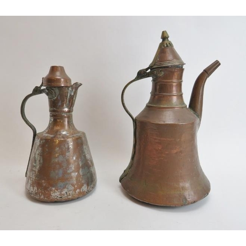 222 - Two Middle Eastern metalwork decanters. Comprising a copper jug of mallet form with hinged cover tog... 