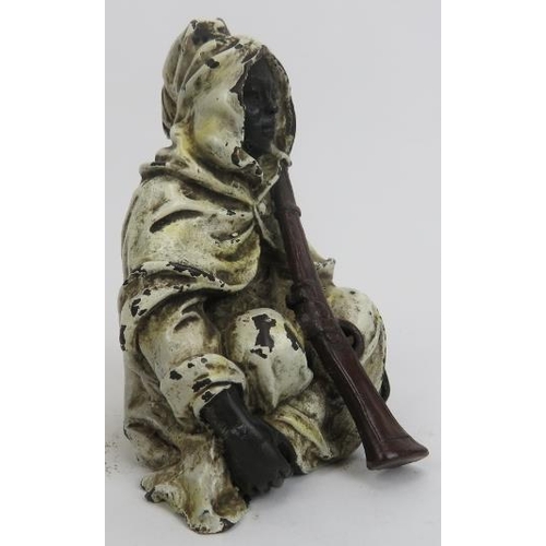 27 - An Austrian style cold painted bronze figure of an Arab with musket. Depicted seated on the ground w... 