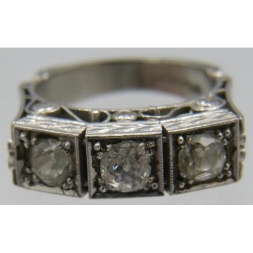 311 - A fine platinum & diamond ring. The three central brilliant cut diamonds in square setting, approx 0... 