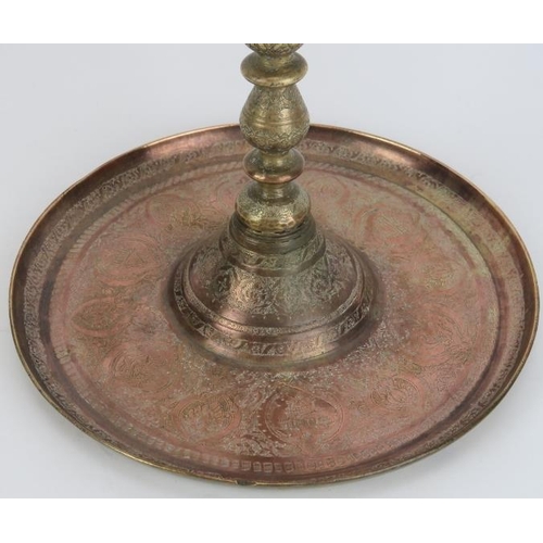 33 - A large Middle Eastern copper and brass astray on stand, late 19th/early 20th century. With finely e... 