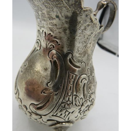 345 - A Victorian silver cream jug embossed with scrolls & flowers, a double scroll acanthus leaf handle &... 