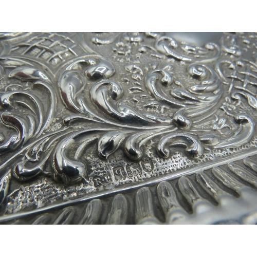 346 - A heavily embossed silver dressing table tray with vacant cartouche, London 1911. Approx 6.3 troy oz... 