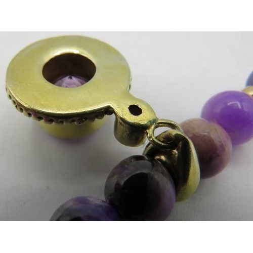 355 - A rare and unusual Russian sugilite bead necklace with yellow metal amethyst pendant. Amethyst 12mm ... 