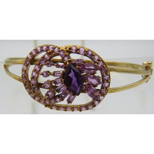 362 - A 9ct yellow gold bangle set with centre marquise cut amethyst approx 12mm x 7mm, which is surrounde... 