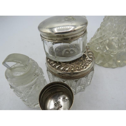 378 - Two cut glass scent bottles with silver collars, two silver topped rouge pots, a small hobnail cut s... 