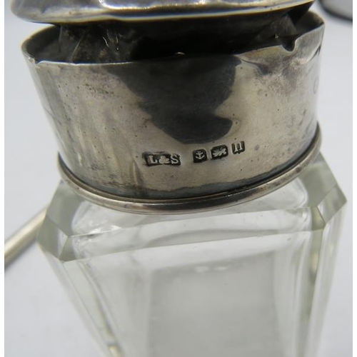 379 - A silver topped cut glass scent bottle with engraved decoration, London 1884, a small scent bottle w... 