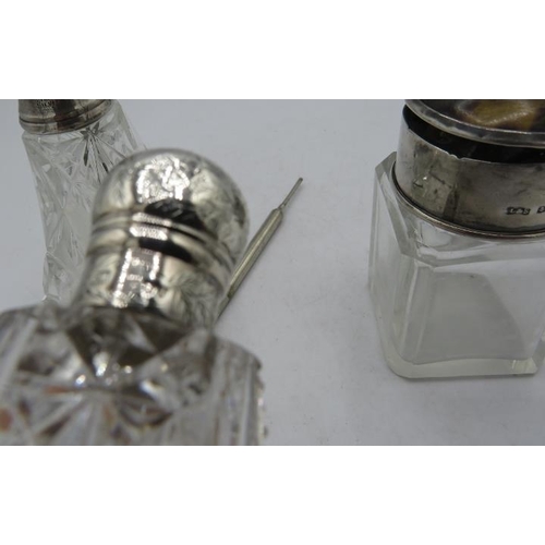 379 - A silver topped cut glass scent bottle with engraved decoration, London 1884, a small scent bottle w... 