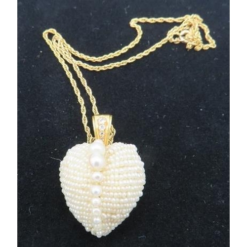 385 - A heart shaped vintage seed pearl pendant with row of larger graduated pearls down the centre. The b... 