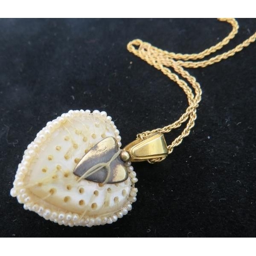 385 - A heart shaped vintage seed pearl pendant with row of larger graduated pearls down the centre. The b... 