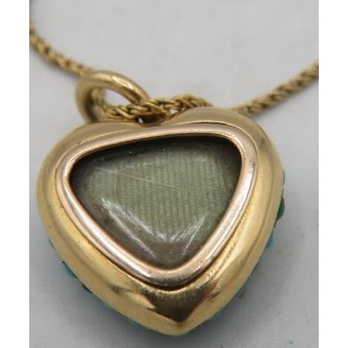 386 - A yellow metal heart shaped turquoise encrusted pendant/locket with a 'V' set with tiny seed pearls ... 