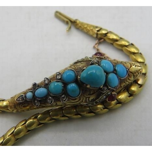 387 - A fine Victorian yellow metal bracelet of serpent biting it's tail. The head is embellished with tur... 