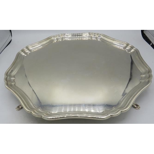 393 - A large heavy silver salver with applied octofoil raised border & pad feet. Approx 14