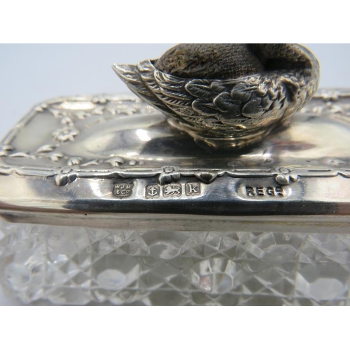 403 - An unusual hobnail cut pin jar with silver top, having attached pin cushion in the shape of a duck o... 