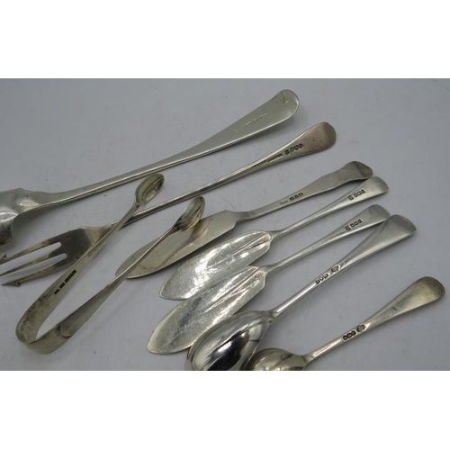 412 - An assortment of silver items to include pickle fork, butter knives, sugar tongs and salt spoon. All... 