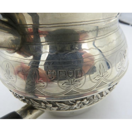 416 - A silver teapot with engraved & embossed decoration, ebonised handle and finial, London 1906. Approx... 