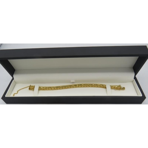 431 - A heavy yellow gold plated jointed bracelet with X design and safety chain, boxed. Approx weight 25.... 