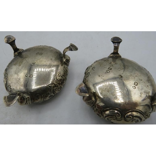 443 - A pair of Victorian circular salts with embossed floral decoration on pad feet and gilded interior, ... 