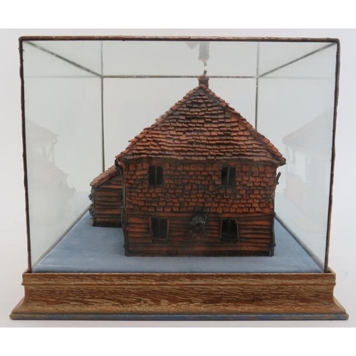 45 - A painted terracotta model of a country cottage, 20th century. Housed within a glass display case. C... 