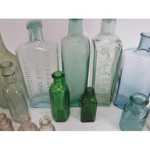 46 - An antique and vintage collection of glass bottles, 19th century and later. (22 items) 11.2 in (28.5... 