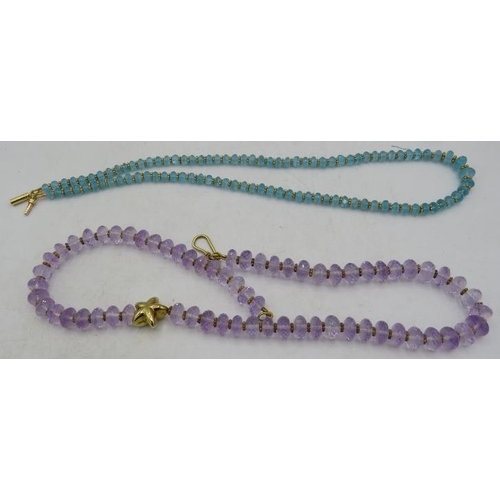 467 - A fine faceted amethyst necklace with yellow metal star & small yellow metal bead spacers on a yello... 