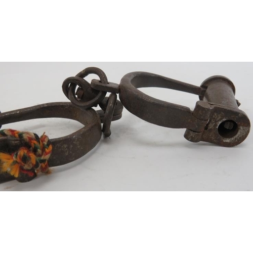 47 - A pair of cast iron handcuff shackles, probably 19th century. Condition report: Some wear with age.