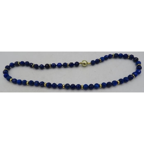 470 - A fine AAAA quality faceted cut lapis lazuli necklace with 14ct yellow gold ball clasp set with emer... 