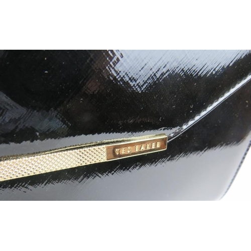 488 - A Ted Baker black patent handbag with gold coloured trim, with dust bag.
Provenance: Part of a priva... 