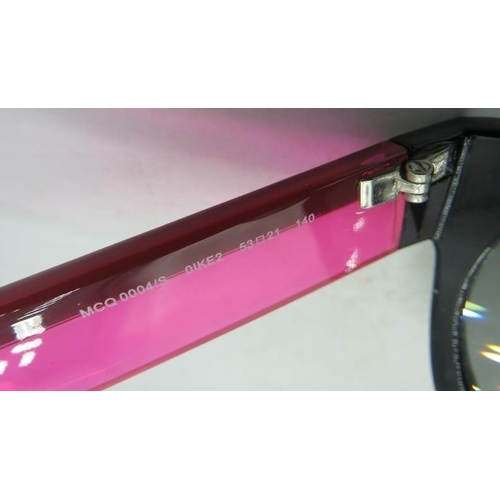 498 - Alexander McQueen black sunglasses with pink and black arms, cased.
Provenance: Part of a private co... 