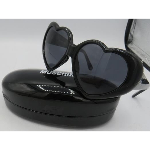 500 - Moschino black heart shaped sunglasses, cased.
Provenance: Part of a private collection of designer ... 