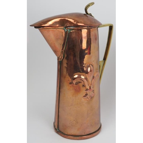 73 - An Arts & Crafts copper and brass ewer, late 19th century. Modelled with a hinged cover, angular han... 